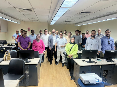 Dr. Moustafa Awad with a Banque Misr AI in Banking cohort during a lab session.